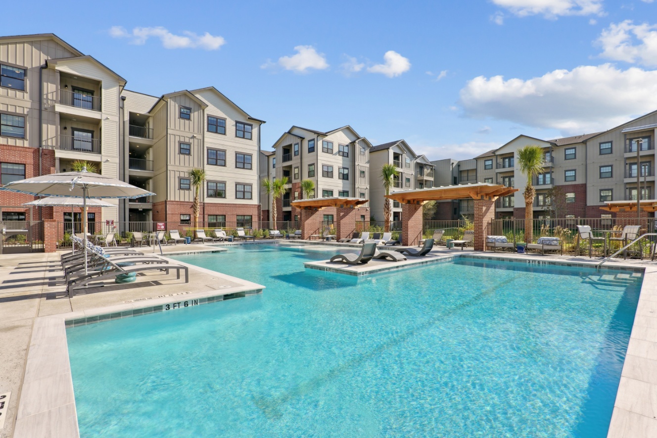 Resort-style swimming pool and sundeck loungers at Brazos Oaks